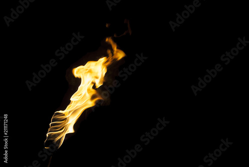 flame of a torch in the dark on a black background, only the fire is visible