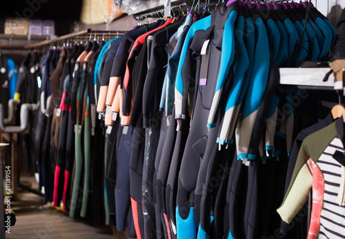 Image of colorful wetsuit hanging in the store for surfing