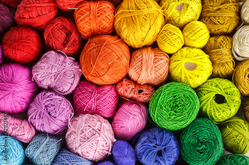 Rainbow-colored yarn balls, viewed from above.