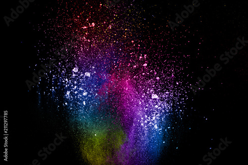 Abstract multi color powder explosion on black background. Freeze motion of color dust particles splash. Painted Holi in festival.
