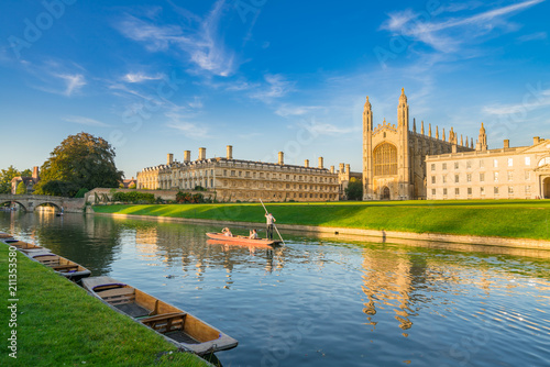 Beautiful view of college in Cambridge with people punting on river cam