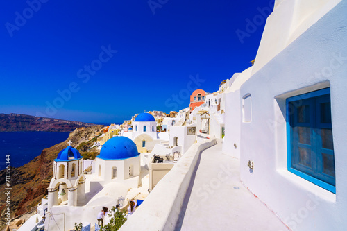 Oia town on Santorini island, Greece. Traditional and famous houses and churches with blue domes