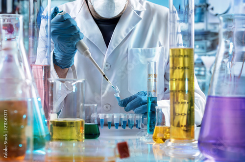 chemical engineer working in the research laboratory / researcher holding test tube with chemist material in the investigation lab 