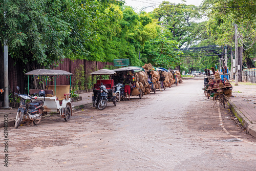 Motor bikes with attached carts on a street in Siem Reap, Cambodia.