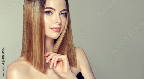 Beautiful model girl with shiny brown and straight long hair .Keratin straightening .Treatment, care and spa procedures.Medium length hairstyle. Coloring, ombre,and highlighting 