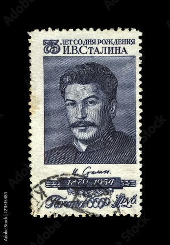 Joseph Stalin, famous soviet politician leader, 75th birth anniversary, circa 1954.. vintage canceled postal stamp printed in USSR (Soviet Union) isolated on black background.