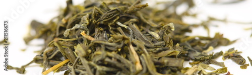 Pile of green tea on white background. Shallow dof
