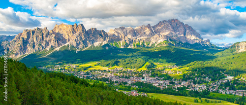 Panorama of Cortina d'Ampezzo with green meadows and alpine peaks on the background. Dolomites, Italy