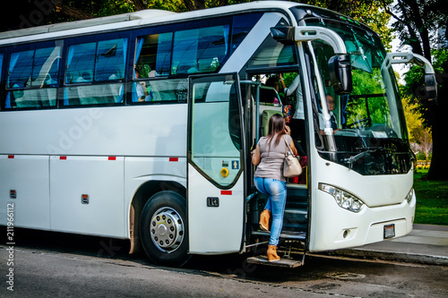 transport, tourism, road trip and people concept - passenger boarding to travel in bus