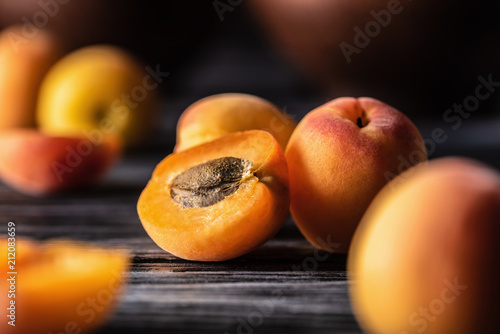selective focus of ripe apricots on wooden table