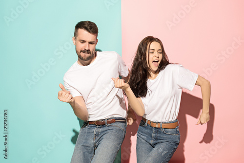 A couple of young man and woman dancing hip-hop at studio.