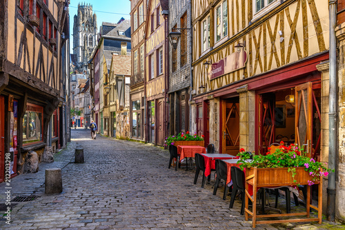 Cozy street with timber framing houses and tables of restaurant in Rouen, Normandy, France