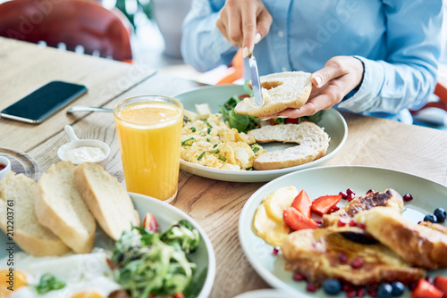 Close up of woman eating delicious and healthy breakfast in restaurant