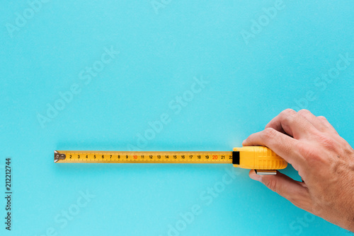 Handyman measuring size with tape meter