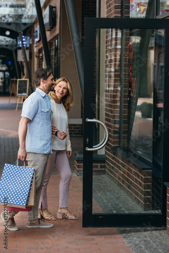 side view of couple entering shopping mall