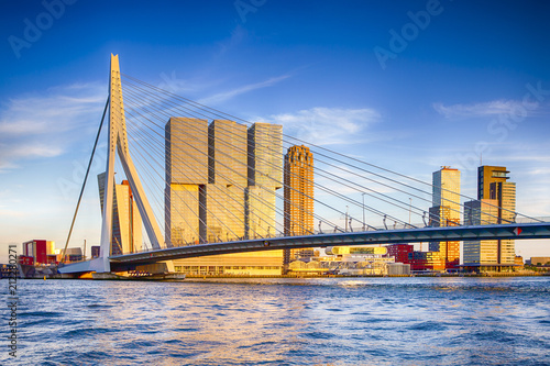 Famous Travel Destinations. Attractive View of Renowned Erasmusbrug (Swan Bridge) in Rotterdam in front of Port and Harbour. Picture Made Before the Sunset.