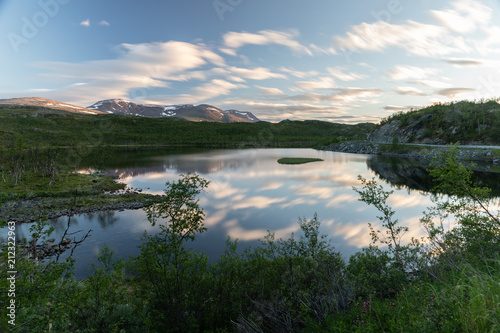 Beautiful mountain scenery in Northern Norway. Water reflecting the clouds.