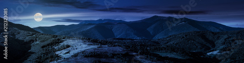 beautiful panorama of mountain ridge at night in full moon light. wonderful landscape in early autumn