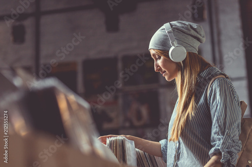 Young girl with headphones in a music store