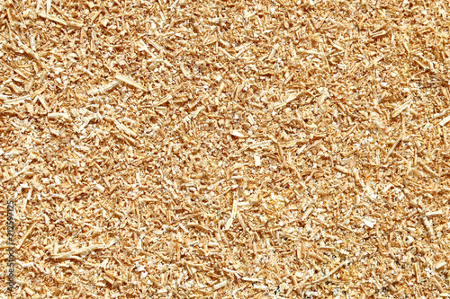 Natural wood sawdust background. Waste wood processing in the workshop.