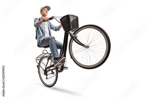 Teenager doing a wheelie with a bicycle