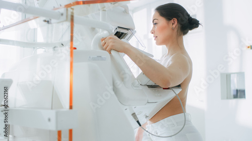 In the Hospital, Portrait Shot of Topless Female Patient Undergoing Mammogram Screening Procedure. Healthy Young Female Does Cancer Preventive Mammography Scan. Modern Hospital.