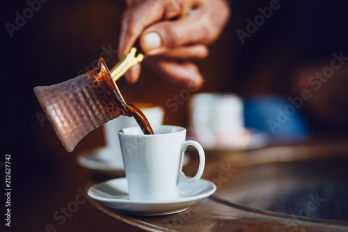 Hand pouring Turkish coffee