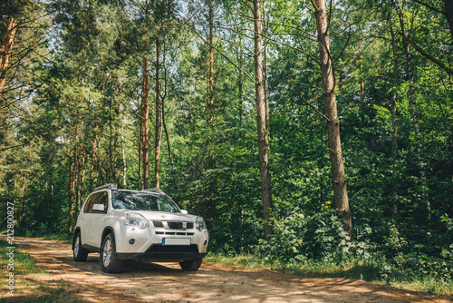 white suv in forest. car travel concept. lifestyle