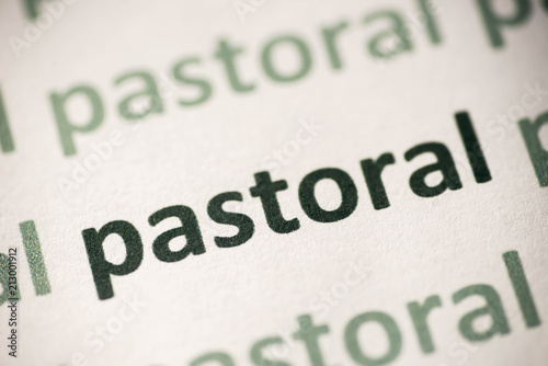 word pastoral printed on paper macro