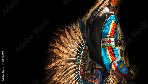 Native American Indian. Close up of colorful dressed native man isolated on black background.