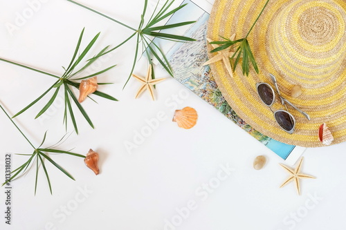 Traveler accessories, tropical palm leaf branches on white background with empty space for text. Travel vacation, weekend concept. Summer background. Flat lay, top view.