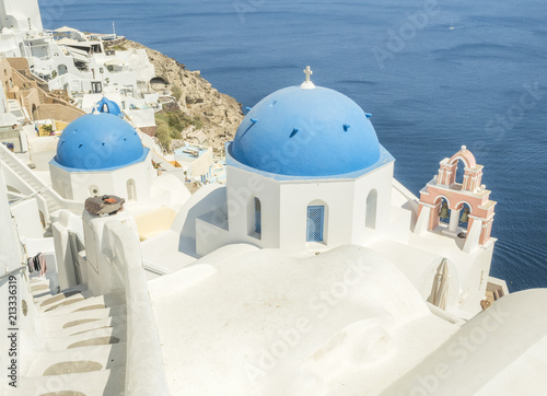 White Church with bells and blue dome at Oia, Santorini, Greek Islands