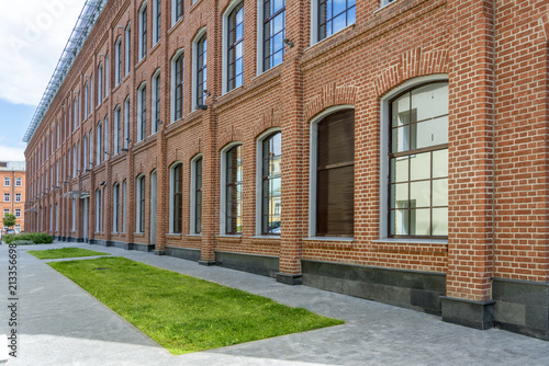 Office building in loft style. large Windows. Red brick wall.