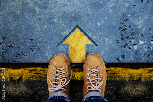 Motivation and Success Concept. Top View of Male with Leather Shoes satnding on the Crossroad to Making Decision to Steps or Stop. Forward Arrow on the Floor as background