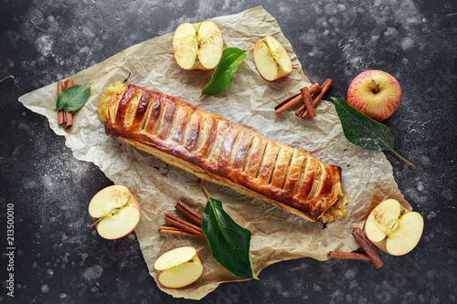 Freshly baked Apple and cinnamon strudel on baking paper