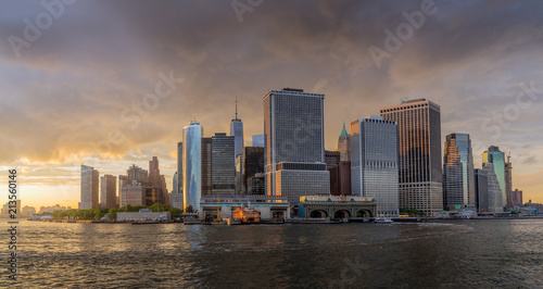 Panorama view of NYC Lower Manhattan skyline with sailboat passing by in New York Harbor