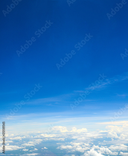Beautiful view of blue sky above the white clouds from airplane window