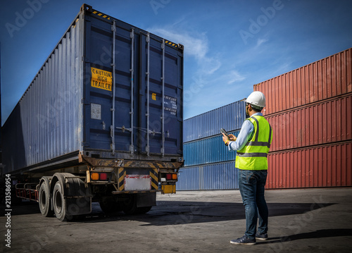 Foreman control loading Containers box to truck for Logistic Import Export Background, Business logistic concept, import and export concept...