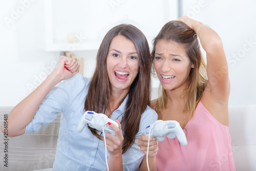two girls are playing videogames