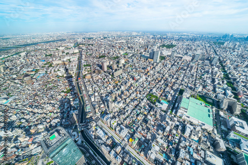 Asia Business concept for real estate and corporate construction - panoramic modern city urban skyline bird eye aerial view under sun & blue sky in Tokyo, Japan