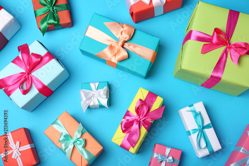 Flat lay composition with beautiful gift boxes on color background