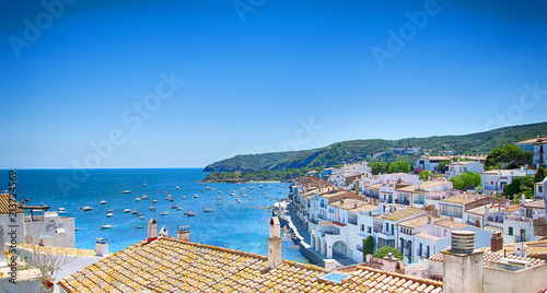 View on Street in Cadaques, Catalonia, Spain near of Barcelona. Scenic old town with nice beach and clear blue water in bay. Famous tourist destination in Costa Brava with Salvador Dali landmark