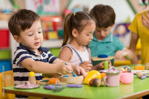 Childs are playing with play clay in classroom