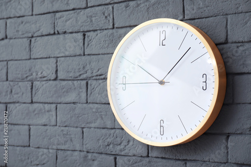 Modern clock on brick wall. Time concept