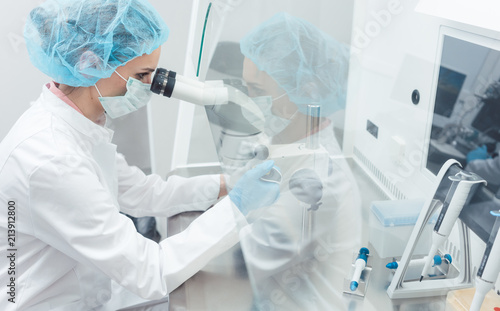 Doctor or scientist working on biotech experiment in laboratory