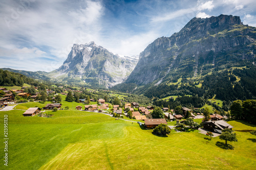 Sunny view of alpine Eiger village. Location place Swiss alps, Grindelwald valley.