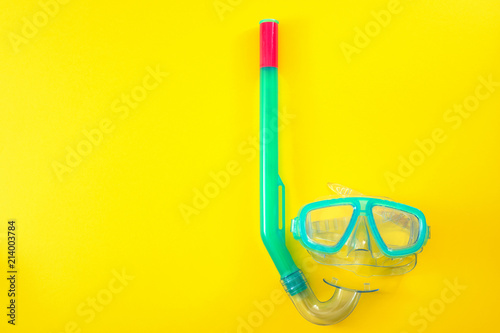 Summer vacation, beach activities and having fun on holiday concept with flat lay image of a snorkeling mask isolated on yellow minimalist background with copy space