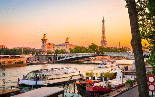Sunset view of Eiffel Tower, Alexander III Bridge and river Seine in Paris, France.