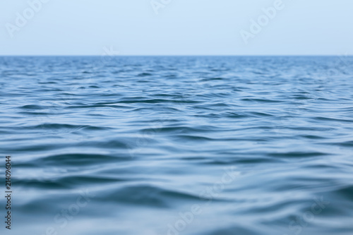 Surface of the sea with small waves. Seascape under a clear sky in a calm.
