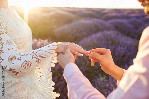 Marriage proposal in a field of lavender in the evening at sunset.